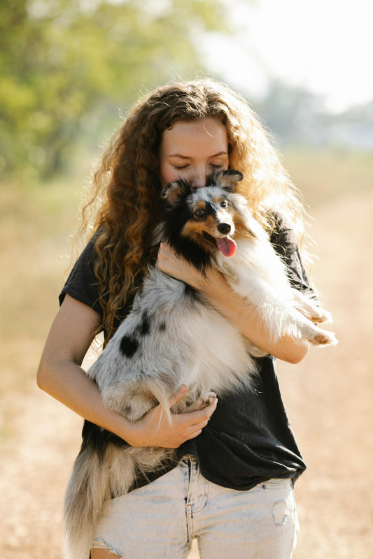 A Girl hugging her Healthy dog after Vet visit