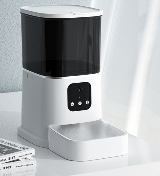 Pet automatic feeder on a white surface with a neutral background