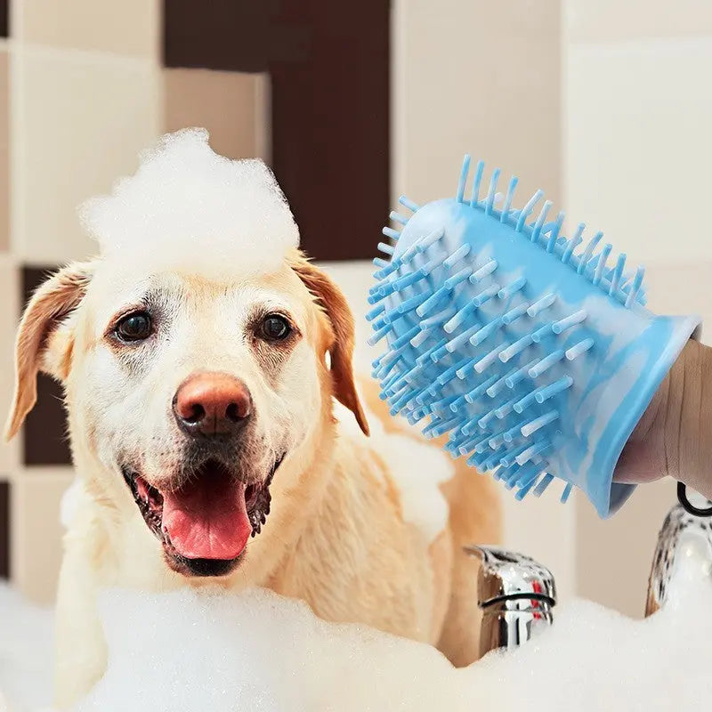 Pawssibly Pets blue dog paw cleaner silicone glove with bristles used on happy dog during bath