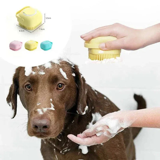 Dog being bathed with a yellow silicone dog bath brush, showing close-up of scrubber and soap bubbles.