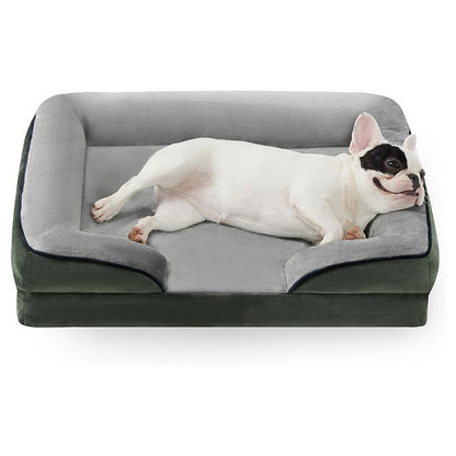 Dog lying on a gray and black orthopedic dog bed with a white background