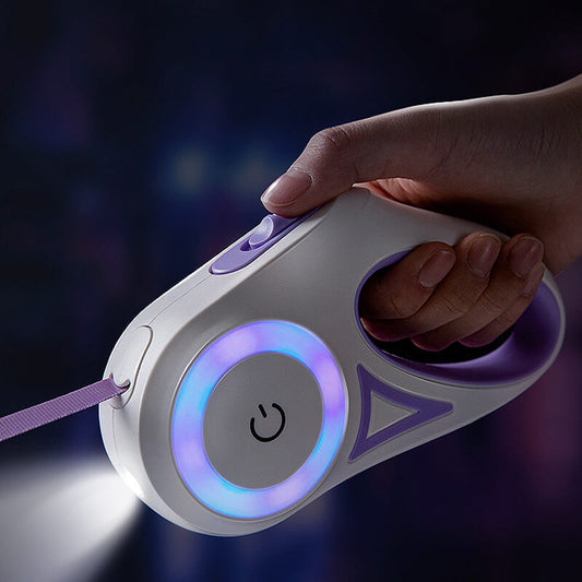 Hand holding a retractable dog leash with glowing elements against a dark background