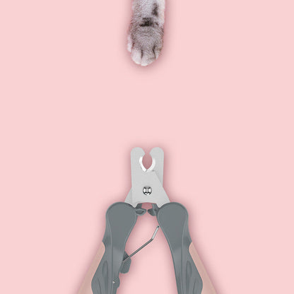 Pawssiblypets dog nail clippers positioned below a cat paw on a pink background